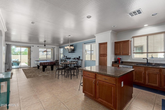157 N 110th Ave, Avondale, AZ 85323 - kitchen with a sink, crown molding, light tile patterned flooring, a center island, and brown cabinets