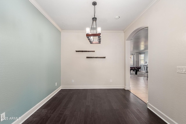 157 N 110th Ave, Avondale, AZ 85323 - unfurnished dining area featuring arched walkways, ornamental molding, wood finished floors, and baseboards
