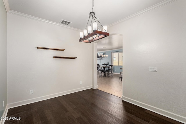 157 N 110th Ave, Avondale, AZ 85323 - spare room featuring a chandelier, baseboards, crown molding, arched walkways, and wood finished floors