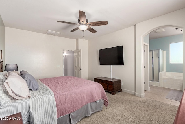 157 N 110th Ave, Avondale, AZ 85323 - carpeted bedroom featuring arched walkways, a ceiling fan, ensuite bath, tile patterned floors, and baseboards