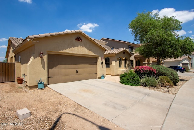 157 N 110th Ave, Avondale, AZ 85323 - mediterranean / spanish-style house featuring stucco siding, an attached garage, concrete driveway, and a tiled roof