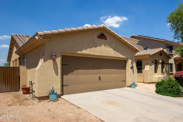 157 N 110th Ave, Avondale, AZ 85323 - mediterranean / spanish house with an attached garage, stucco siding, a tiled roof, and concrete driveway