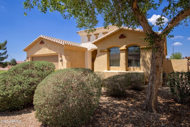 157 N 110th Ave, Avondale, AZ 85323 - mediterranean / spanish house with an attached garage, stucco siding, and a tile roof