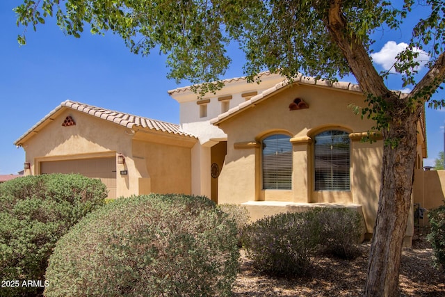 157 N 110th Ave, Avondale, AZ 85323 - mediterranean / spanish home featuring a garage, a tile roof, and stucco siding