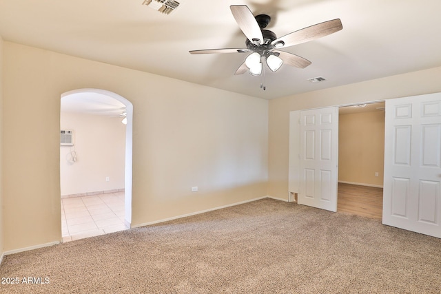 carpeted spare room featuring ceiling fan