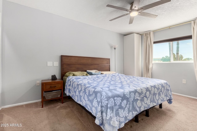 bedroom with carpet, baseboards, and a textured ceiling