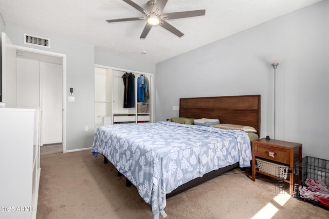 bedroom with ceiling fan, a closet, visible vents, and light colored carpet