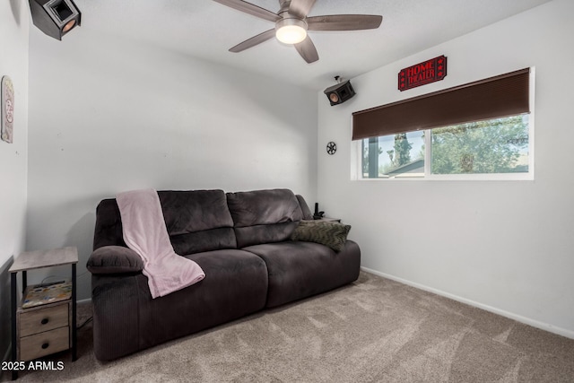 living area with ceiling fan, carpet floors, and baseboards