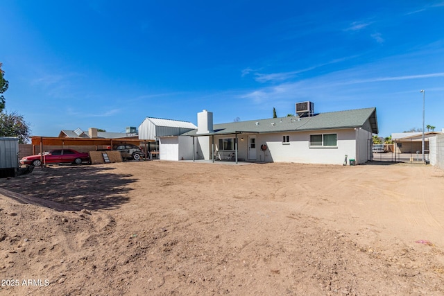 back of property with fence and central air condition unit