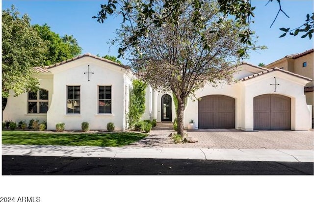 mediterranean / spanish home with a garage