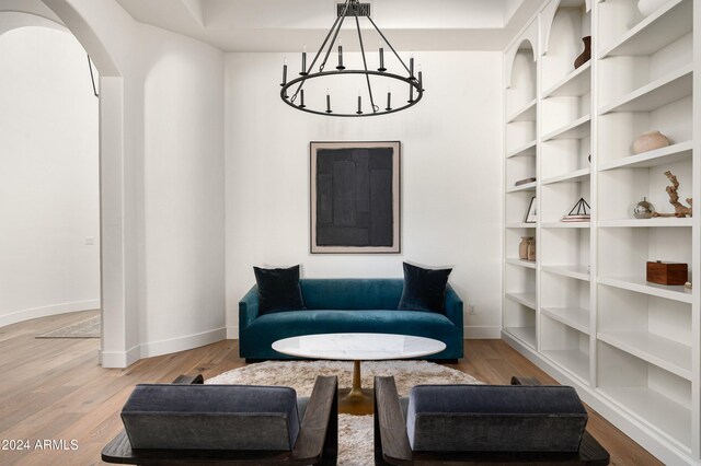 sitting room with light hardwood / wood-style flooring and an inviting chandelier