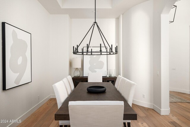 dining space with wood-type flooring