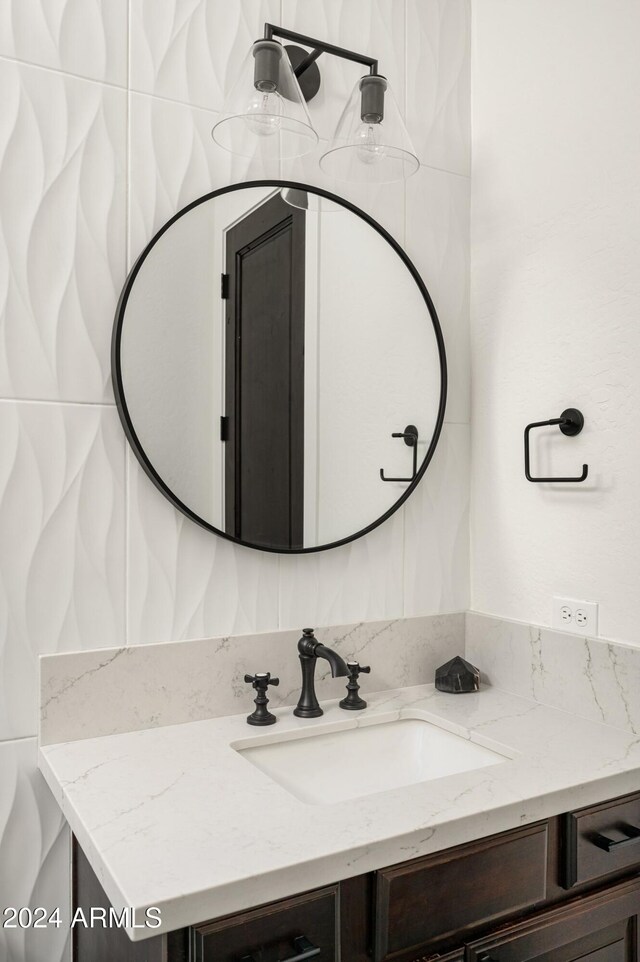 bathroom with vanity and tasteful backsplash