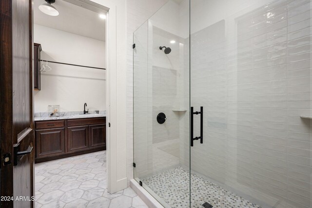 bathroom featuring vanity and a shower with shower door