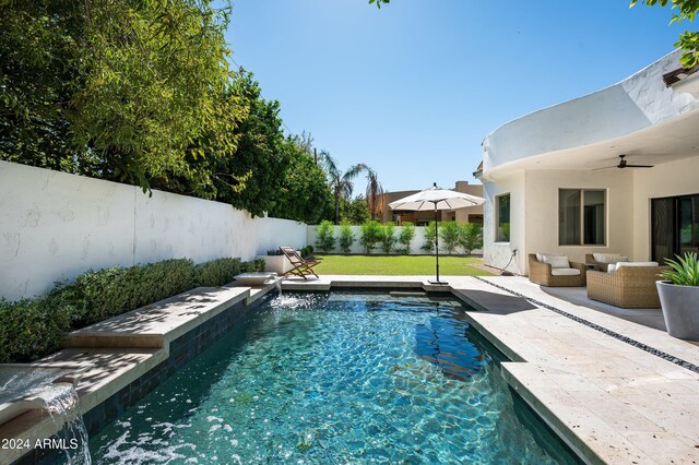 view of swimming pool with a patio area, a yard, an outdoor hangout area, ceiling fan, and pool water feature