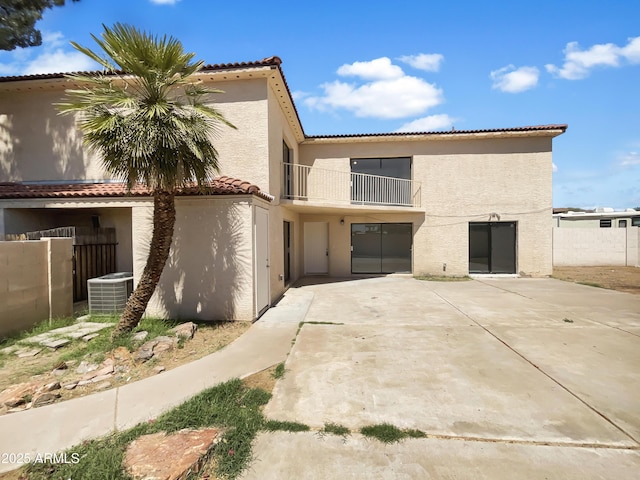 15650 N 19th Ave Unit 1206, Phoenix, AZ 85023 - view of front facade with a balcony, stucco siding, a tile roof, and central AC unit
