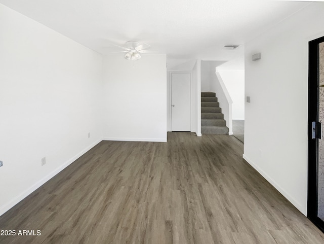 15650 N 19th Ave Unit 1206, Phoenix, AZ 85023 - unfurnished living room with a ceiling fan, wood finished floors, stairs, and baseboards