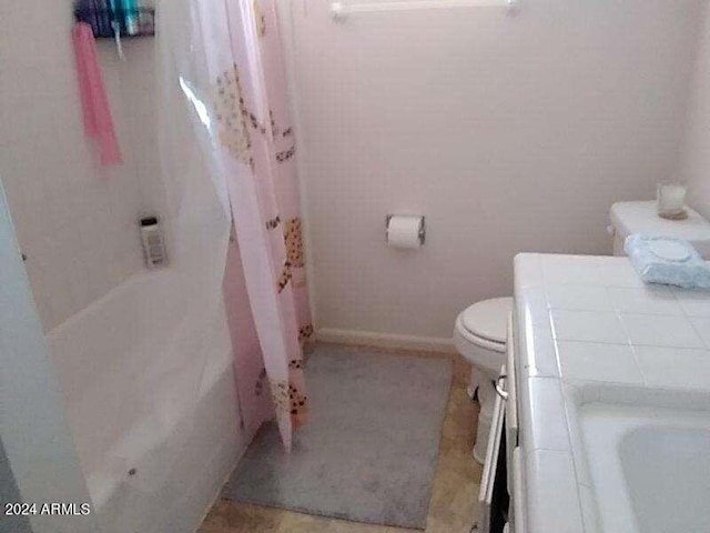 bathroom with a tub and toilet