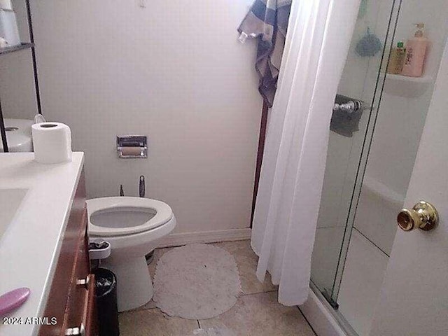 bathroom featuring toilet, an enclosed shower, and vanity