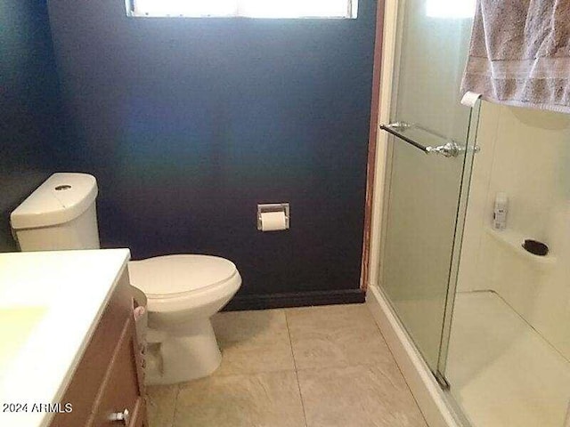 bathroom with vanity, toilet, plenty of natural light, and tile patterned floors