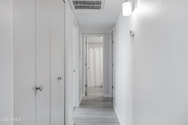 corridor featuring light wood-type flooring