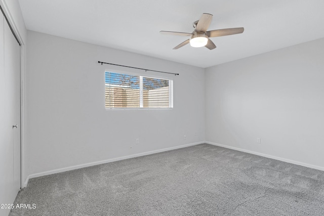 carpeted spare room with ceiling fan