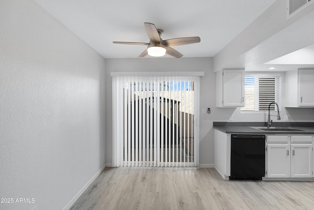 kitchen featuring sink, white cabinets, black dishwasher, ceiling fan, and light wood-type flooring