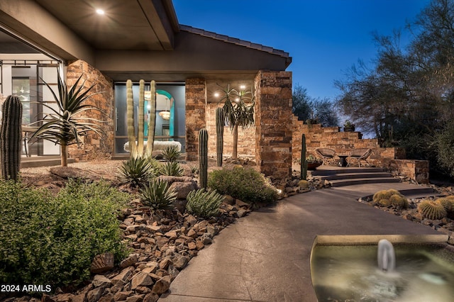 property exterior at night with a patio area