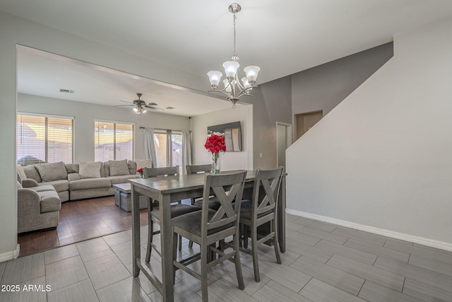 dining area with ceiling fan with notable chandelier