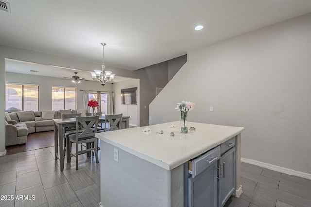 kitchen featuring pendant lighting, plenty of natural light, gray cabinets, and a center island