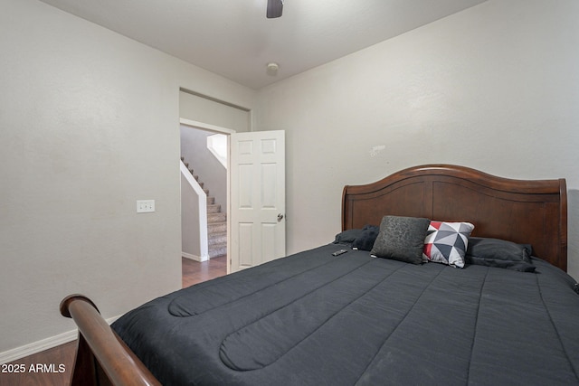 bedroom with dark hardwood / wood-style floors and ceiling fan