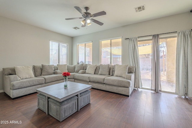 living room featuring dark hardwood / wood-style flooring and ceiling fan