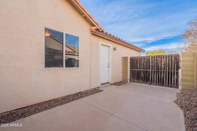 view of patio / terrace with fence and a gate