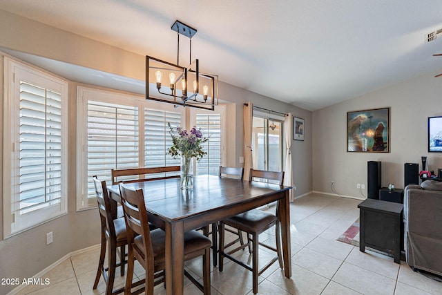 dining room with baseboards, visible vents, lofted ceiling, a chandelier, and light tile patterned flooring