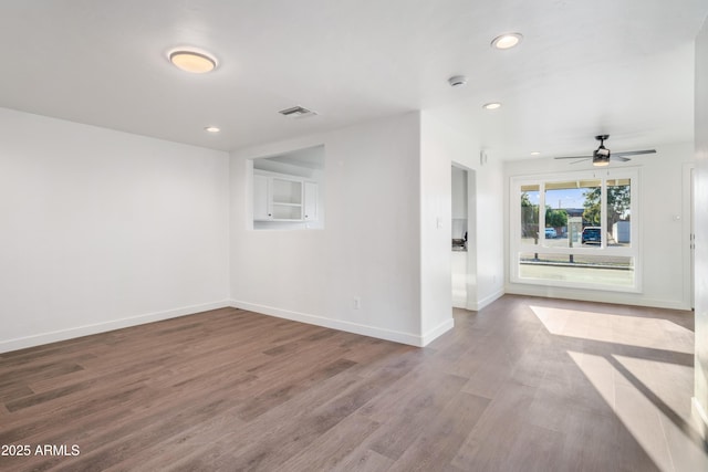 empty room with recessed lighting, a ceiling fan, baseboards, and wood finished floors