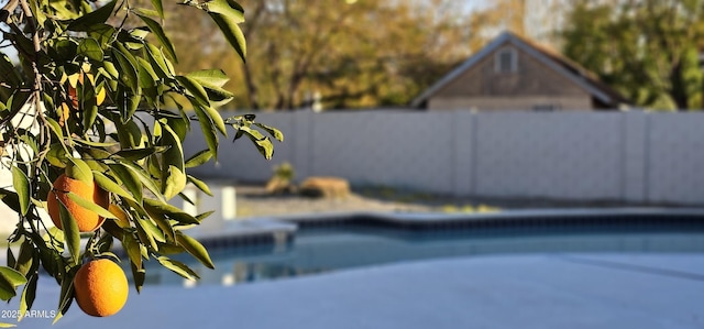 view of swimming pool with fence