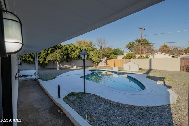 view of swimming pool with a patio area, a fenced backyard, and a fenced in pool