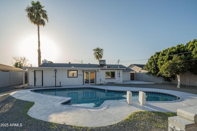 view of pool featuring a fenced in pool, central AC unit, a fenced backyard, and a patio area