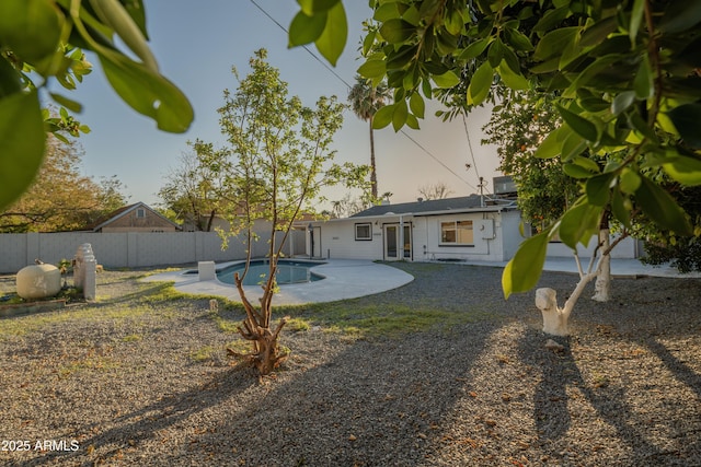 back of house featuring french doors, a patio, a fenced in pool, and a fenced backyard