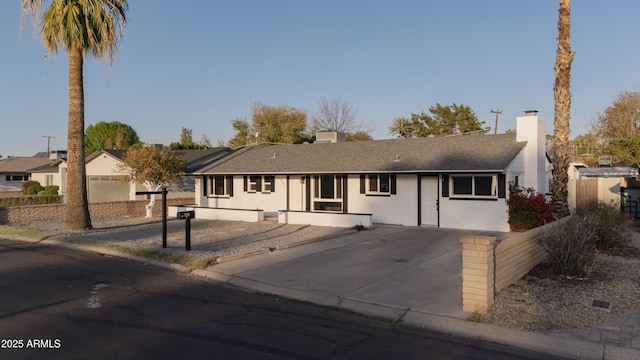 ranch-style home with fence