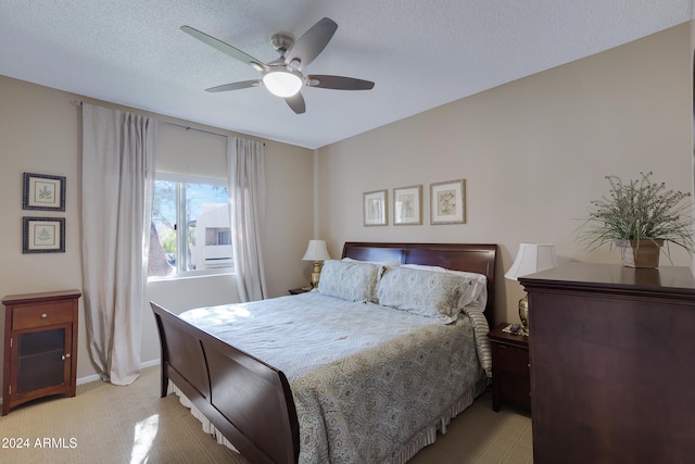 bedroom with ceiling fan and a textured ceiling