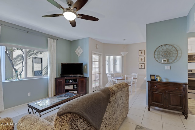 tiled living room with ceiling fan and a wealth of natural light