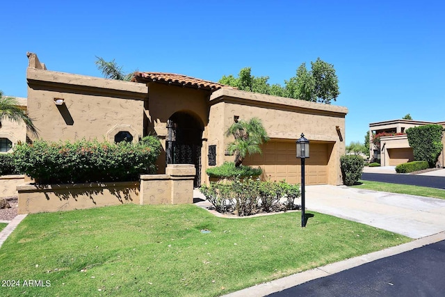 23014 N 86th St, Scottsdale, AZ 85255 - mediterranean / spanish-style home with a front yard, driveway, an attached garage, stucco siding, and a tiled roof