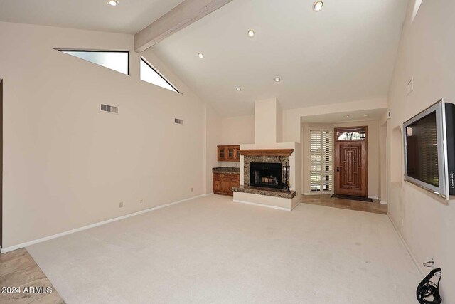 unfurnished living room featuring light carpet, beamed ceiling, and high vaulted ceiling