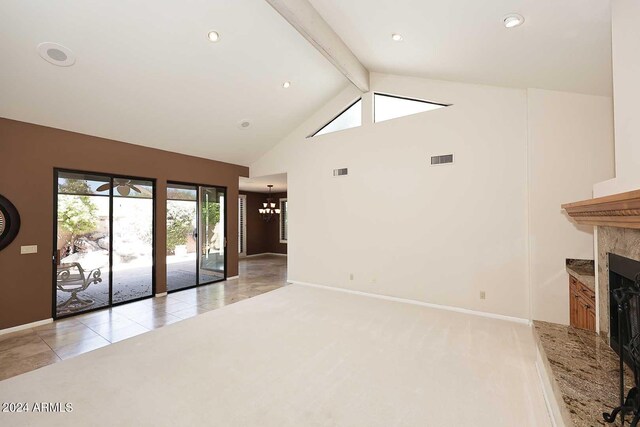 unfurnished living room with light tile patterned flooring, lofted ceiling with beams, and a notable chandelier