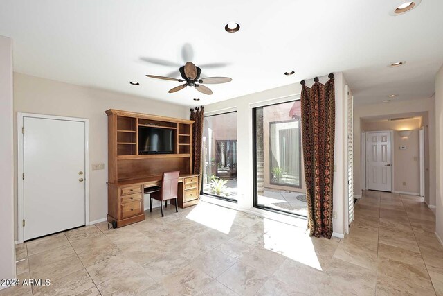 unfurnished office featuring ceiling fan