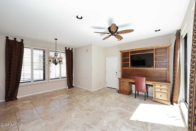 unfurnished office featuring ceiling fan with notable chandelier, built in desk, and light tile patterned floors