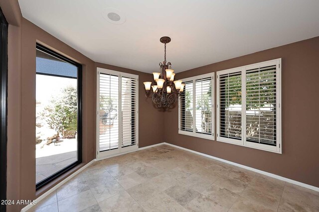 empty room with a notable chandelier