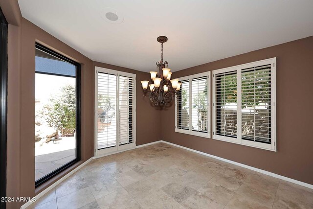 23014 N 86th St, Scottsdale, AZ 85255 - unfurnished room featuring baseboards and a notable chandelier