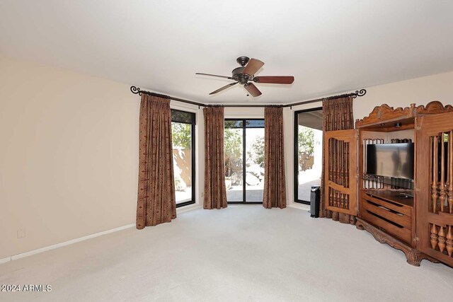 carpeted living room with ceiling fan